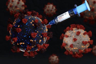 Coronavirus particle being injected by a syringe labelled 'Covid-19 Vaccine'