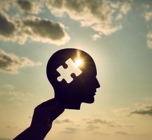 Concept of a human head with a puzzle in the middle.