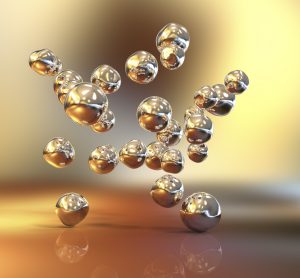 3D illustration of gold nanoparticles falling from above onto a shiny gold surface