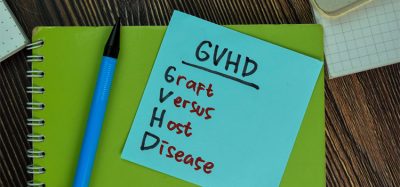 GVHD - Graft Versus Host Disease write on notes isolated on Wooden Table.