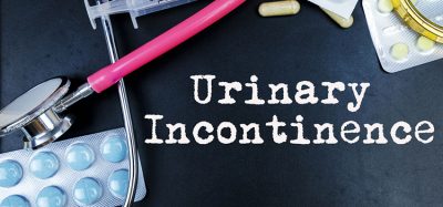 Urinary Incontinence word, medical term word with medical concepts in blackboard and medical equipment