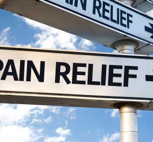 sign saying pain relief to the right