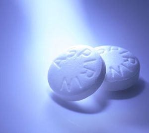White Aspirin macro shot on aqua blue background
