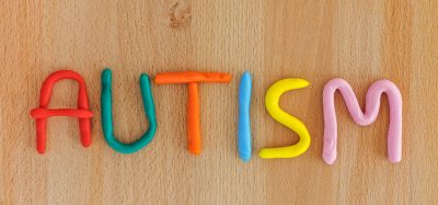 Autism. Autism spectrum disorder(ASD). Autism word made out of playdough. Wooden background. Close up.