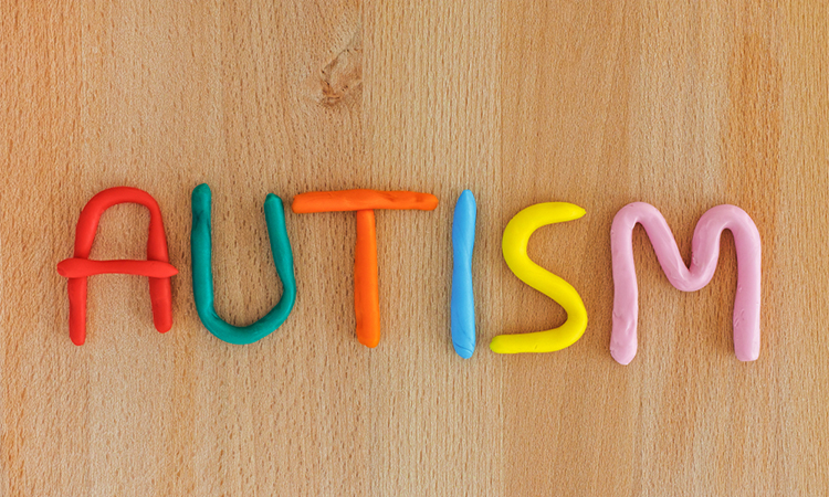 Autism. Autism spectrum disorder(ASD). Autism word made out of playdough. Wooden background. Close up.