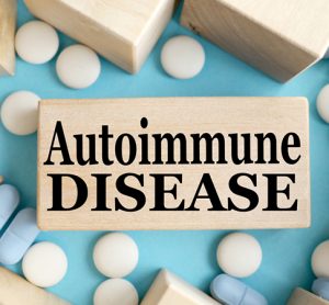 AUTOIMMUNE DISEASE. TEXT ON A WOODEN BAR on a blue background. Medical concept.