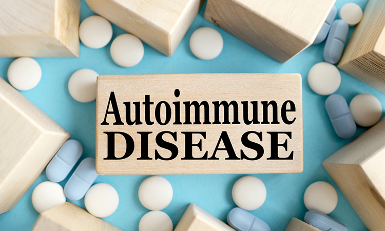 AUTOIMMUNE DISEASE. TEXT ON A WOODEN BAR on a blue background. Medical concept.