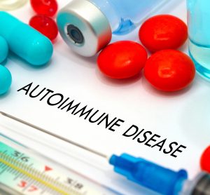 tablets, syringes and drug vials surrounding the words 'autoimmune disease'