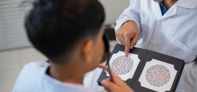 Optometrist or optician get colour blindness tested for child boy, vision and eye care concept