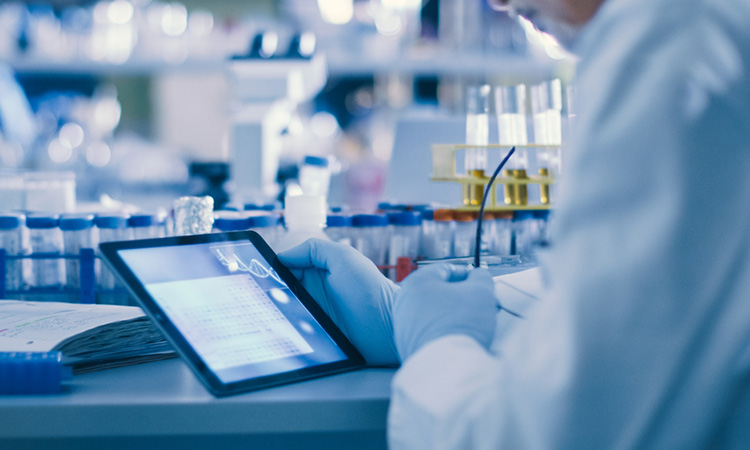 Image showing scientist using a tablet Computer in a Modern High-Tech Laboratory for cancer drug research