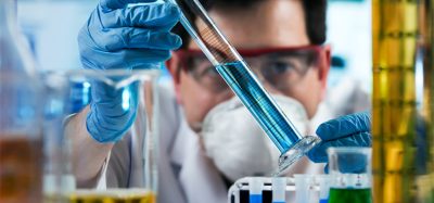 researcher holding test tube with chemist material in the investigation lab / chemical engineer working with tube test in the research laboratory