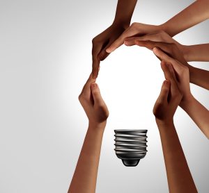 hands coming together to create a lightbulb