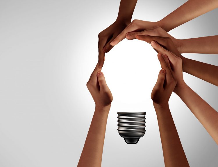 hands coming together to create a lightbulb