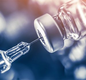 Vaccine vial dose flu shot drug needle syringe,medical concept vaccination hypodermic injection treatment disease care hospital prevention immunization illness disease baby child.blue background