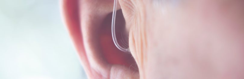 close up of a man's ear with a hearing aid in - idea of deafness