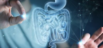 Man on dark background using digital x-ray of human intestine holographic scan projection 3D rendering