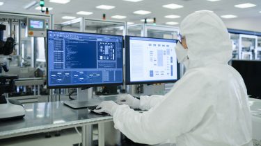 laboratory technician exploring experimental results on computer screens