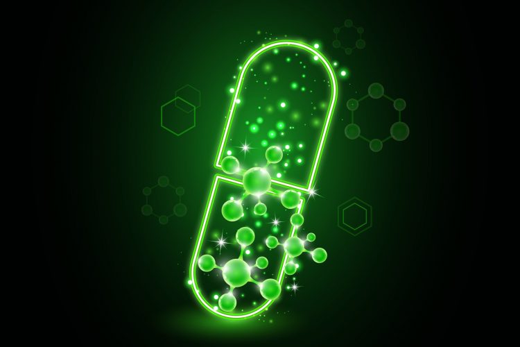Glowing green pill with molecules coming out of it