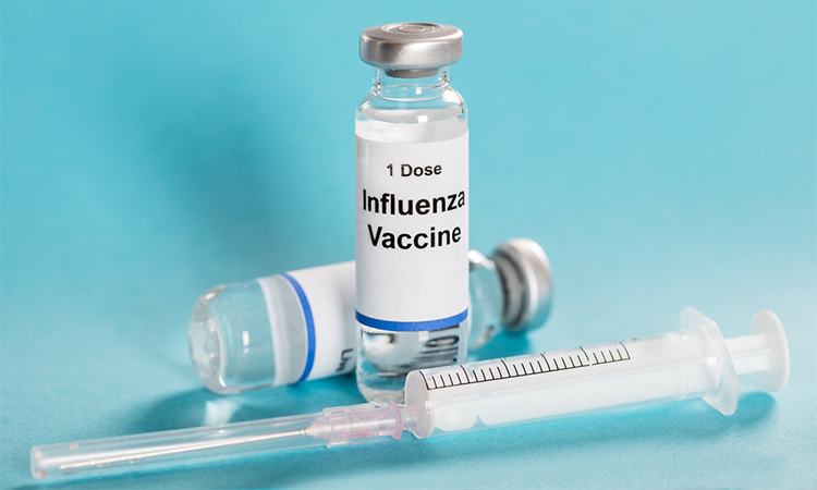 Influenza Flu Vaccine Vials With Syringe Over Turquoise Background