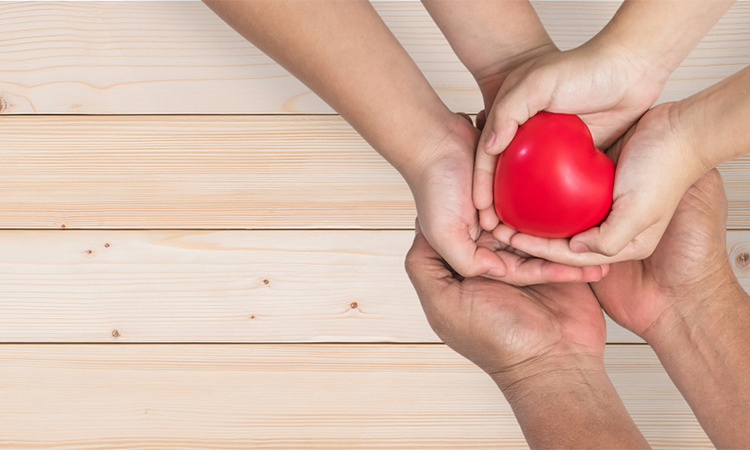 parents' day concept with father-mother or nurse and children supporting red heart together