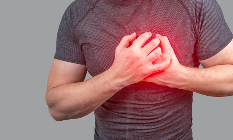 Person clutching chest from acute pain, Heart attack symptom.