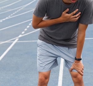 Sport man suffering from chest pain cardiac arrest after running.