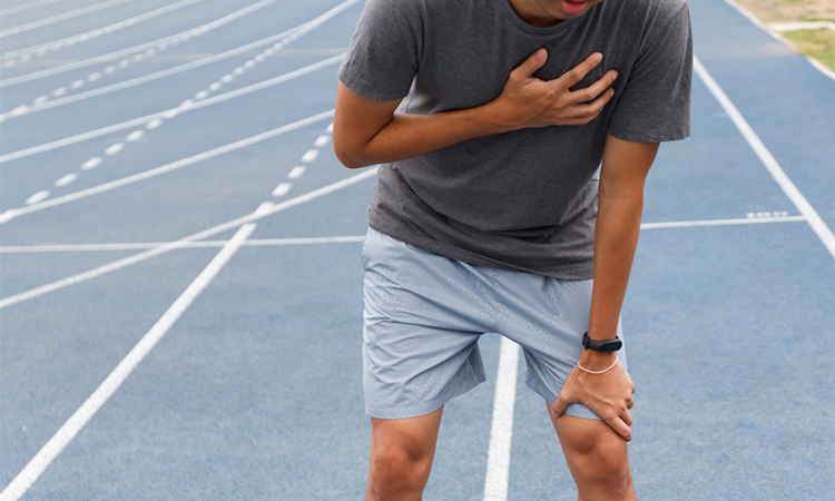 Sport man suffering from chest pain cardiac arrest after running.