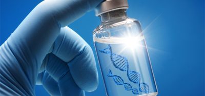 Doctor or scientist shows a vial of genetic agent as a vaccine or therapy against Corona or Covid-19 as a symbolic image