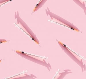 Creative medicinal pattern from needle of pink background. Colorful concept of Flat lay, top view, copy space.