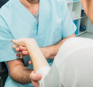 Neurological physical examination of motor neurone diseases. Doctor neurologist checks the status of the patient's reflexes in office in hospital.