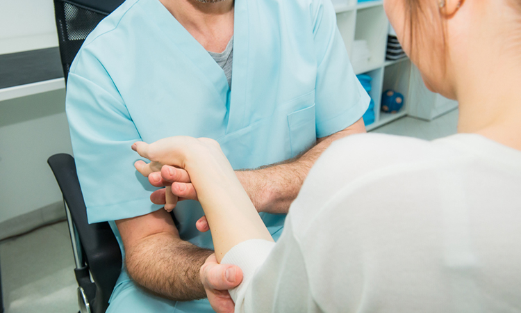 Neurological physical examination of motor neurone diseases. Doctor neurologist checks the status of the patient's reflexes in office in hospital.