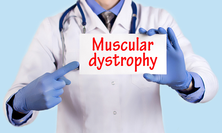 Doctor holds a card that says muscular dystrophy.