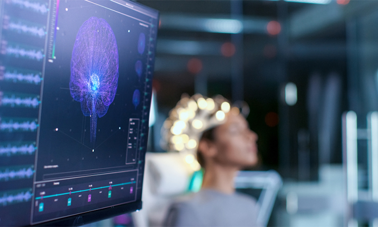 Woman Wearing Brainwave Scanning Headset Sits in a Chair In the Modern Brain Study Laboratory/ Neurological Research Center. Monitors Show EEG Reading and Brain Model.