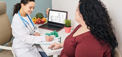 Obesity, unhealthy weight. Nutritionist calculating body mass index of fat woman for obesity treatment