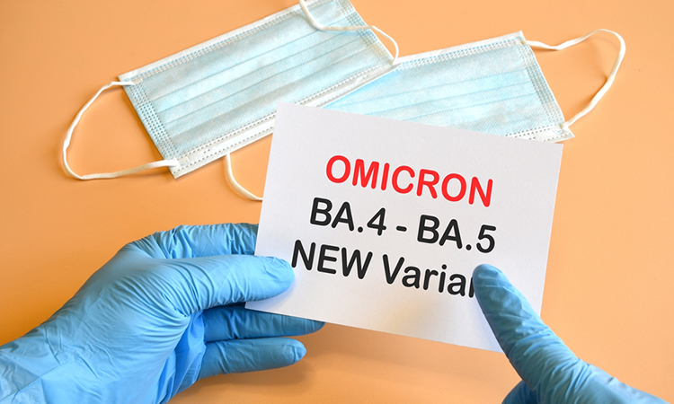 Covid-19 new variants of Omicron. Doctor's hand in blue glove and writing "Omicron BA.4-BA.5 Variant" on white sheet. Concept for the new Covid 19 Omicron variants