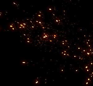 particles like sparks from a fire on a black background