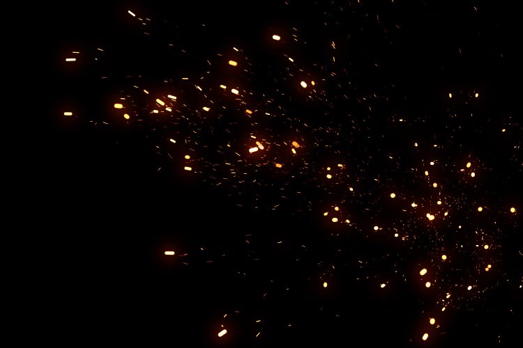 particles like sparks from a fire on a black background