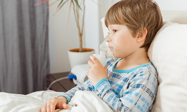 Image showing child with a respiratory syncytial virus, inhaling medication through an inhalation mask.