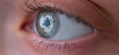 Woman's eye with smart contact lens with digital and biometric implants to scan the ocular retina close up. Concept of future and technology for digital scans