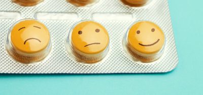 Yellow antidepressant pills with smiley faces drawn on