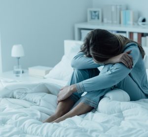 Depressed woman on bed