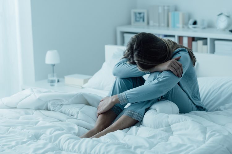 Depressed woman on bed