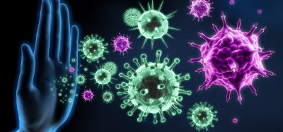 Digital illustration of a human hand blocking floating virus particles, symbolizing the immune system defending against viral infections.