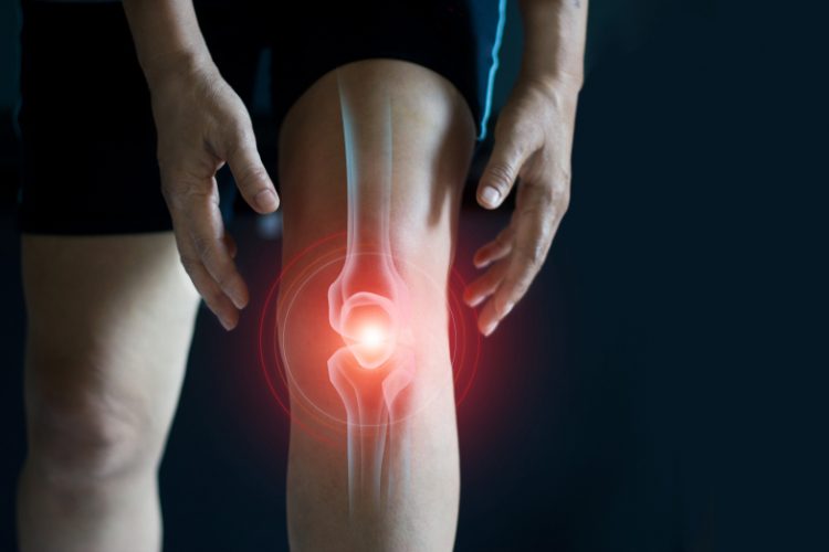 Close-up of man's knee with bone highlighted in red