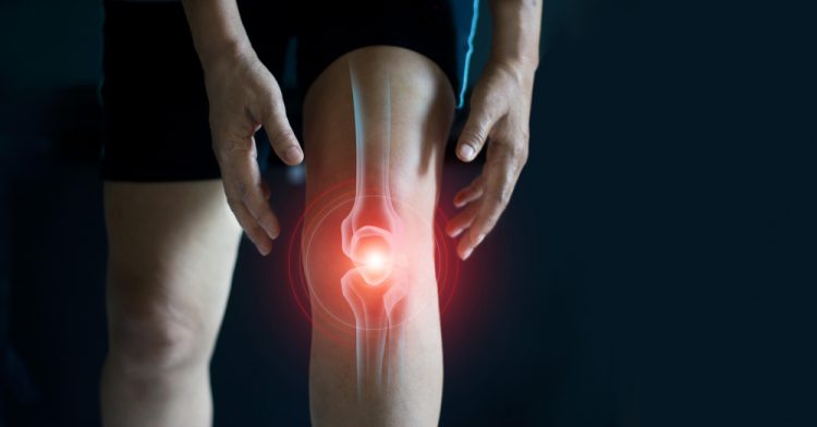 Close-up of man's knee with bone highlighted in red