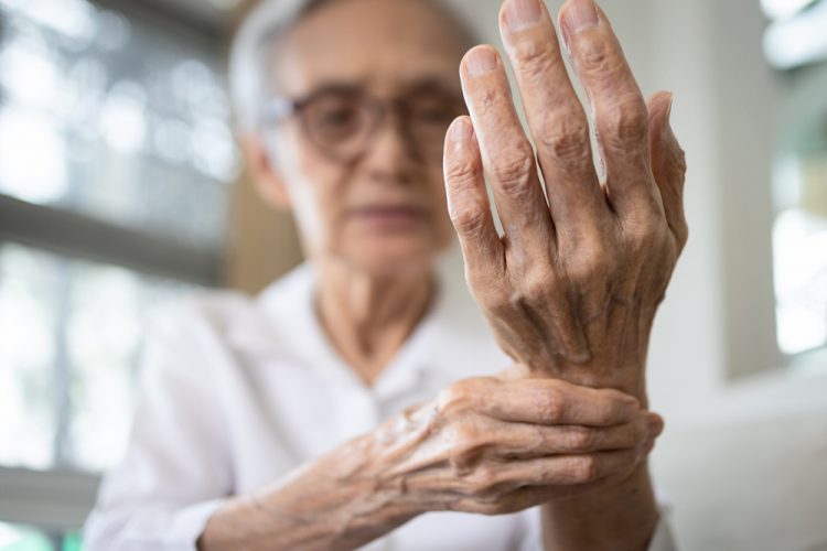 Woman with arthritis holding wrist