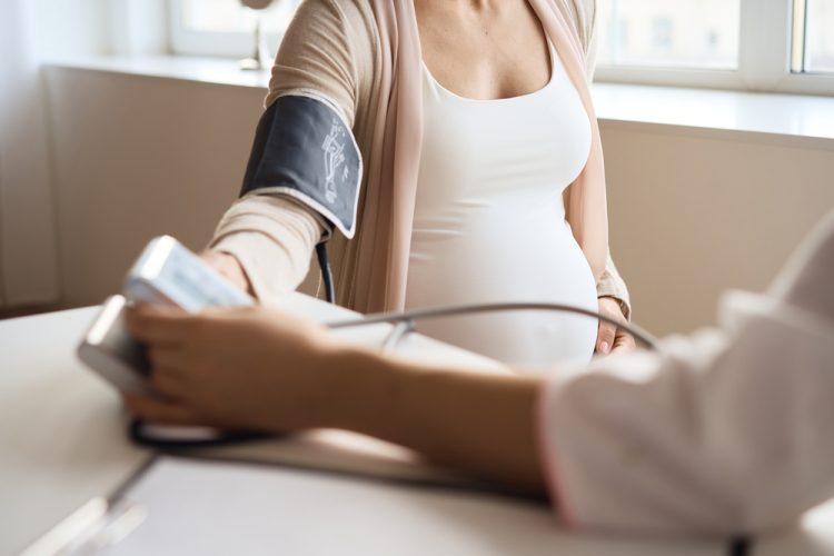 Pregnant woman having her blood pressure taken