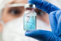 Scientist holding a vial with a digital DNA helix illustration, symbolising advanced gene therapy research