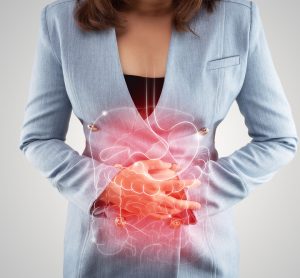 Woman holding stomach with intestine illustration highlighted