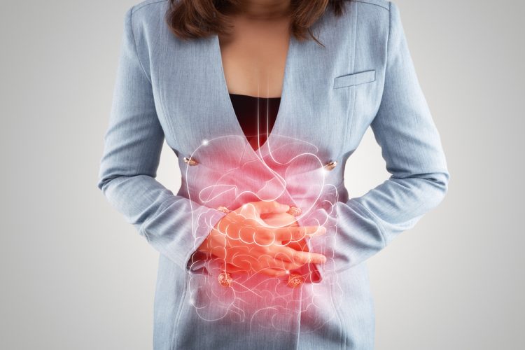 Woman holding stomach with intestine illustration highlighted